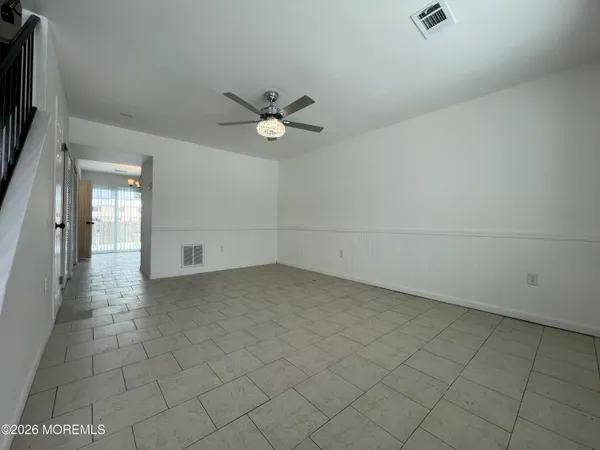 an empty room with a empty space and a ceiling fan