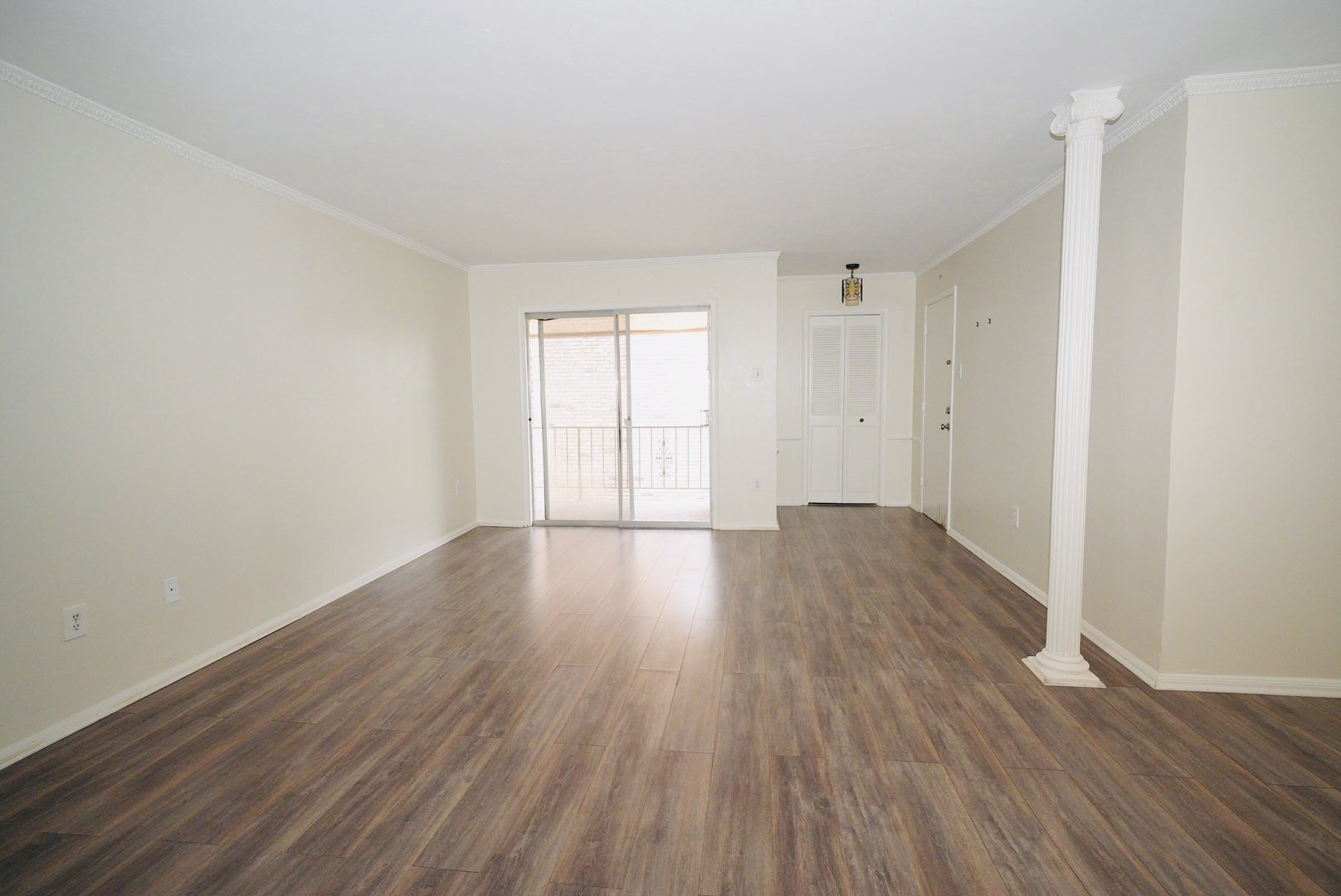 7600 Burgoyne Road, Unit 250 Houston, TX 77063 - Photo 6 of 14 Experience the charm of this spacious living area, featuring elegant hardwood floors and abundant natural light streaming through sliding glass doors.