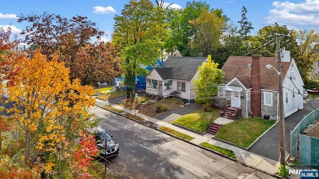 an aerial view of a houses with yard