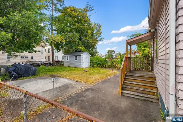 a view of backyard with swimming pool