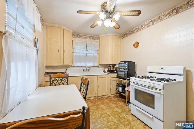a kitchen with a stove a sink and a refrigerator
