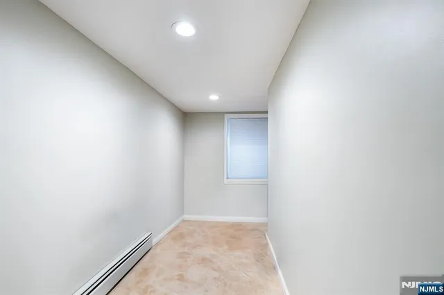 a bedroom with a bed a flat screen tv and a couch