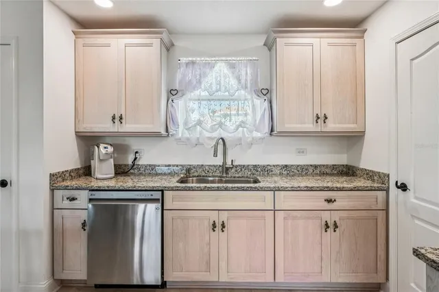 a bed sitting in a bedroom next to a bathroom