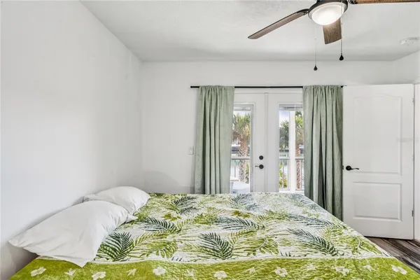 a bedroom with a bed and a chandelier