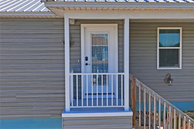 a living room with furniture a chandelier and a window