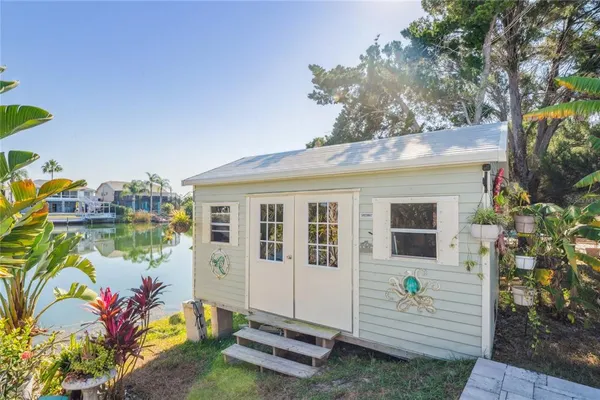 an aerial view of a city with lots of residential buildings ocean and mountain view in back