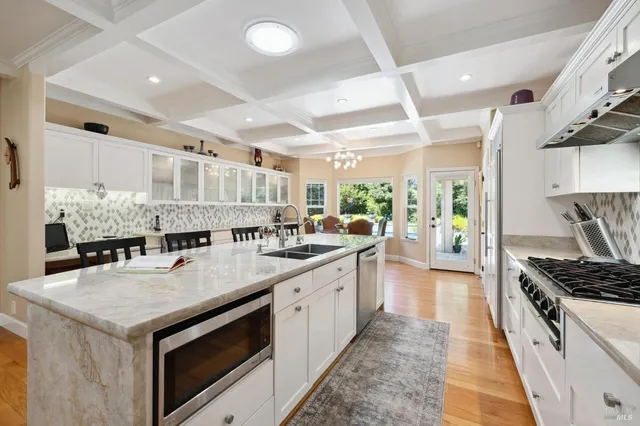 a kitchen with lots of counter top space and stainless steel appliances