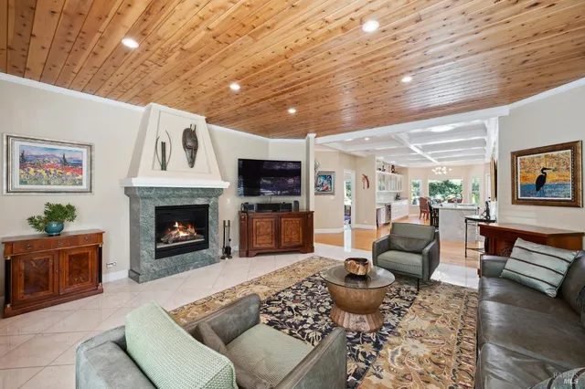 a living room with furniture large window and wooden floor