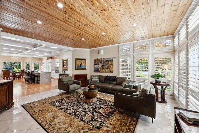 a kitchen with a center island appliances and a large window