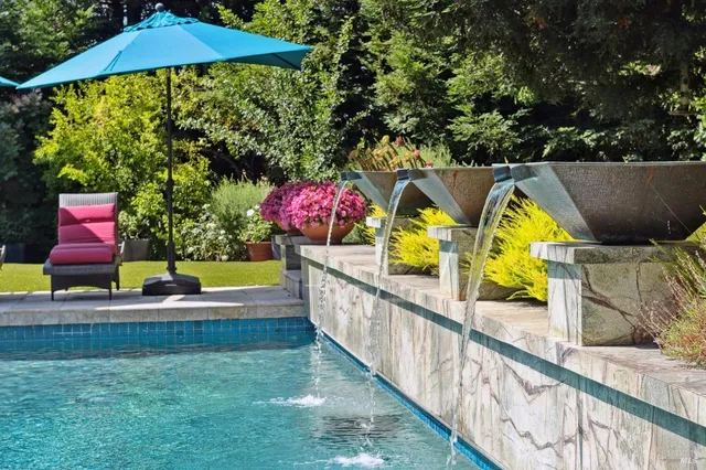 a view of swimming pool with sitting area