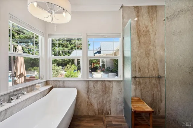 a view of a patio with couches table and chairs and potted plants