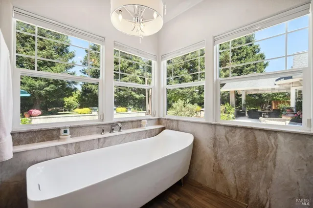 a front view of a house with swimming pool having outdoor seating