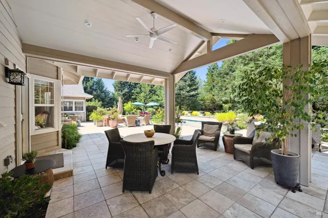 a swimming pool with outdoor seating water slide and barbeque oven