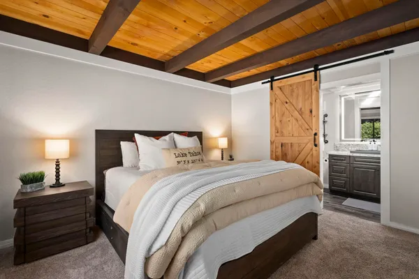 a bedroom with a bed and a lamp
