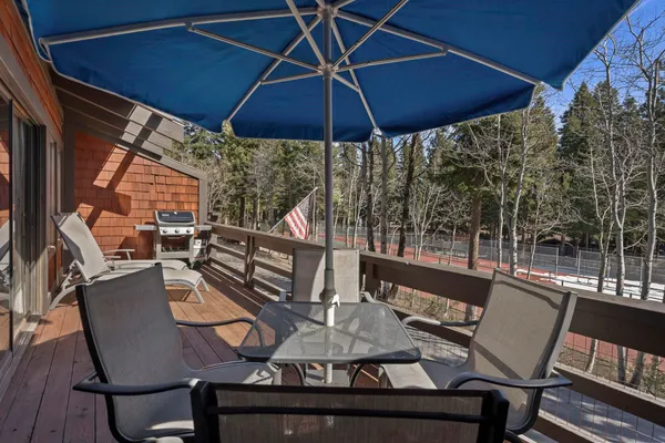 a view of a balcony with furniture and umbrella