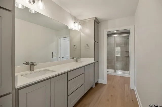 a bathroom with a glass shower door