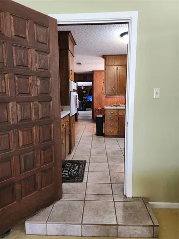 a living room with furniture and a piano
