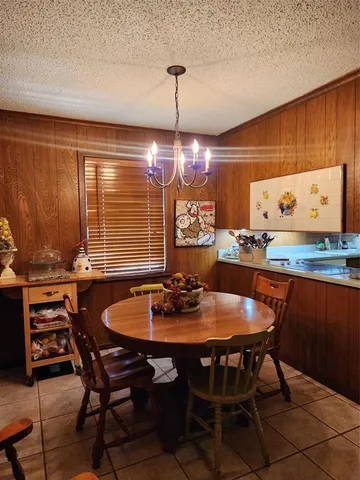 a kitchen with a sink a stove cabinets and counter space