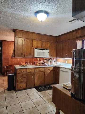 a kitchen with a sink a stove and cabinets