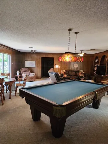 a living room with furniture ceiling fan and a window