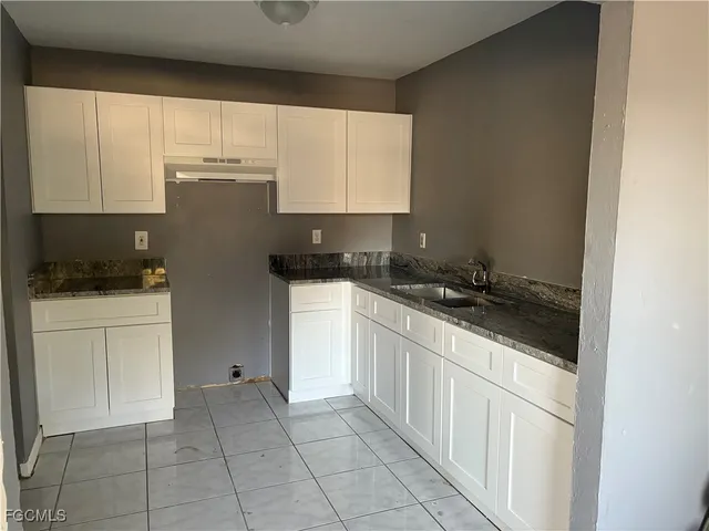 a kitchen with a sink and cabinets
