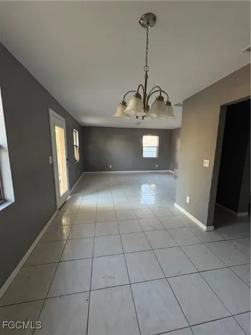 a view of a livingroom with a sink and chandelier