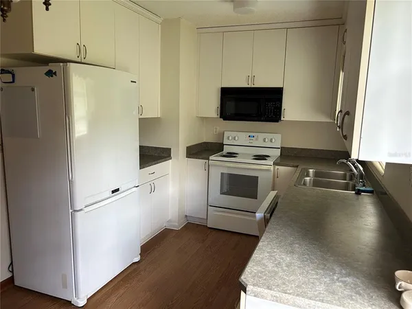a kitchen with a stove and a refrigerator