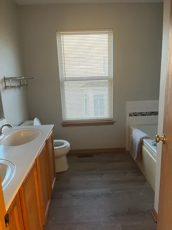 a bathroom with a toilet sink and mirror