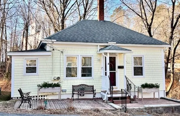 a view of a house with a yard and sitting area