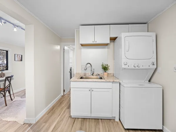 a kitchen with a refrigerator stove and white cabinets