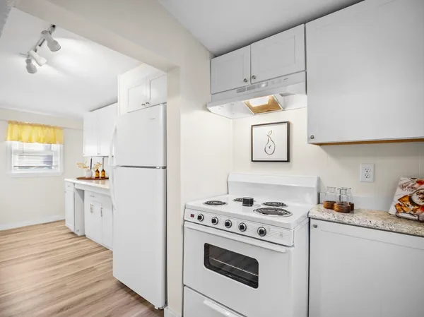 a white refrigerator freezer sitting inside of a kitchen