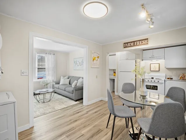 a living room with furniture a refrigerator and a coffee table