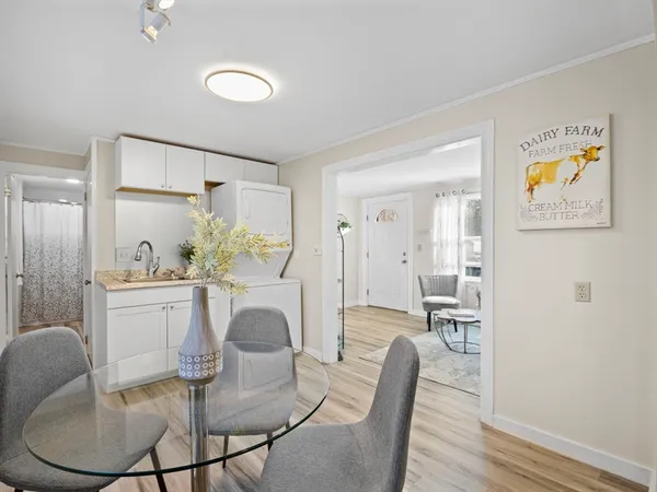 a view of a dining room with furniture and a chandelier