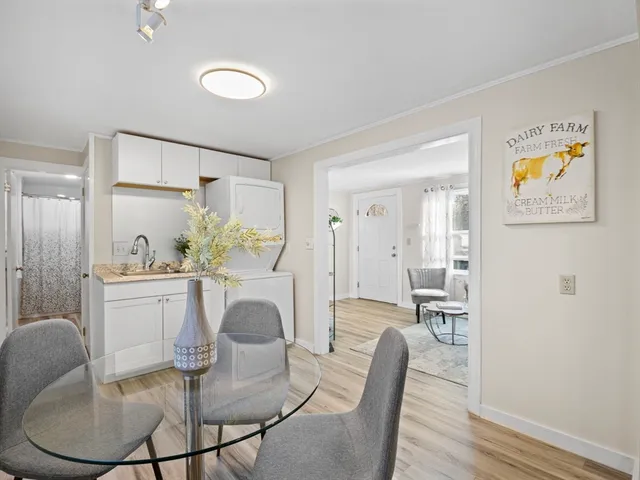 a view of a dining room with furniture and a chandelier