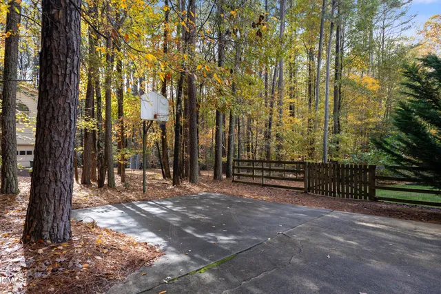 a view of a white house with a small yard and potted plants