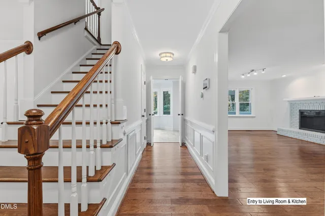 a picture of a room with a white wall and a refrigerator