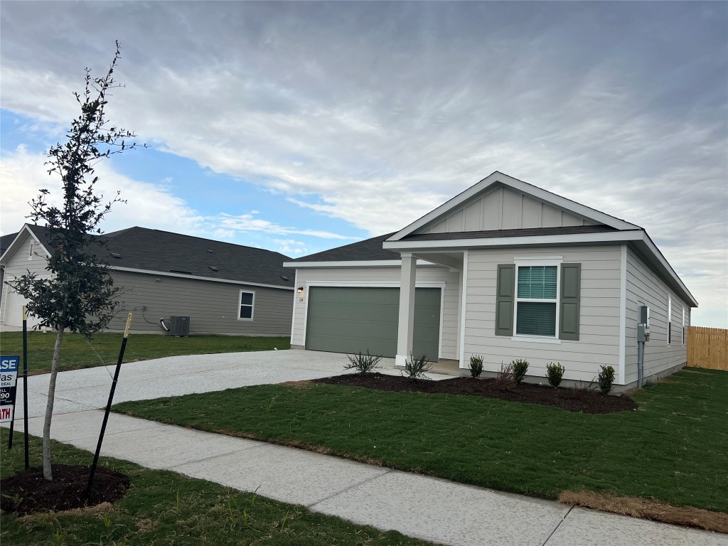 124 Rother Place Taylor, TX 76574 - Photo 1 of 24 a front view of a house with a garden