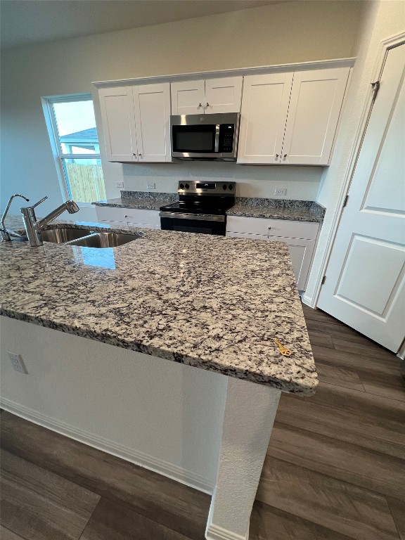 124 Rother Place Taylor, TX 76574 - Photo 9 of 24 a kitchen with granite countertop a sink and a stove top oven