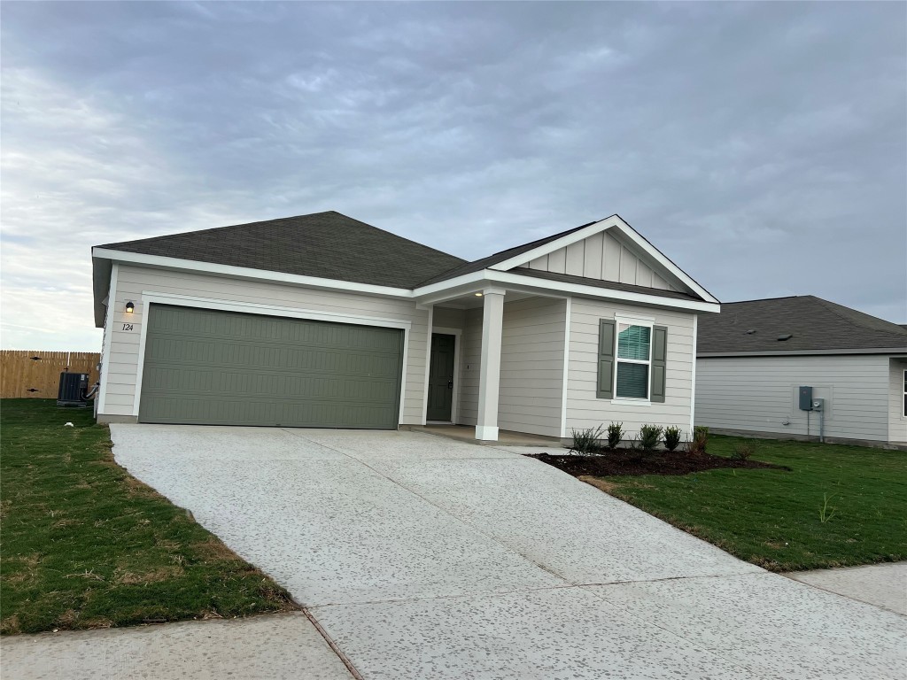 124 Rother Place Taylor, TX 76574 - Photo 2 of 24 a front view of a house with a yard and garage
