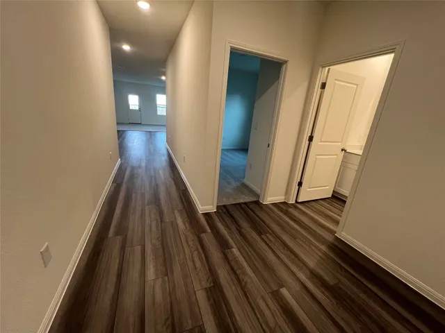 a view of a hallway and wooden floor