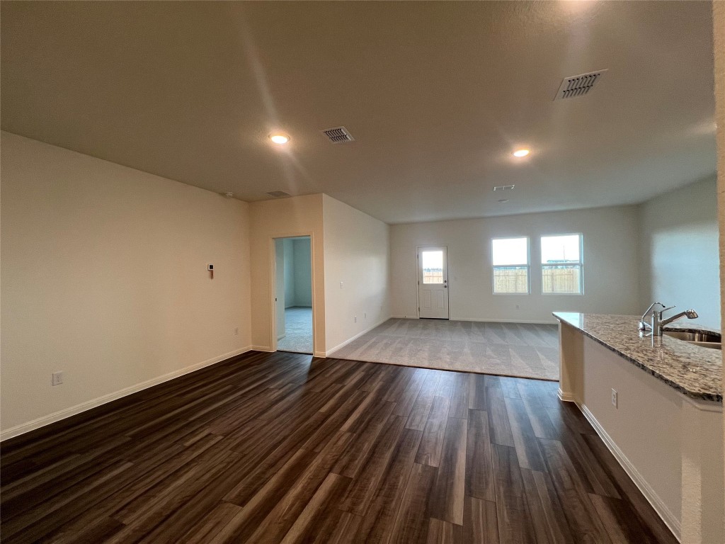124 Rother Place Taylor, TX 76574 - Photo 5 of 24 a view of empty room with wooden floor and fan