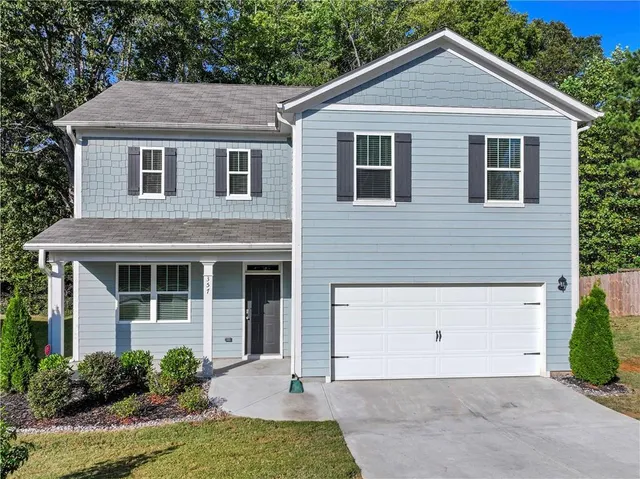 a front view of a house with garden