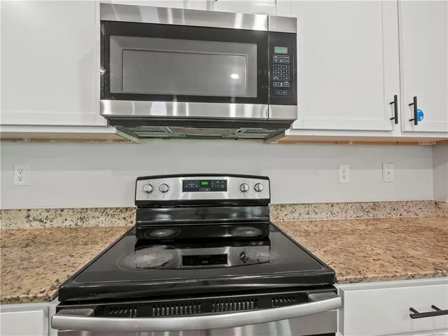 a stove top oven sitting inside of a kitchen