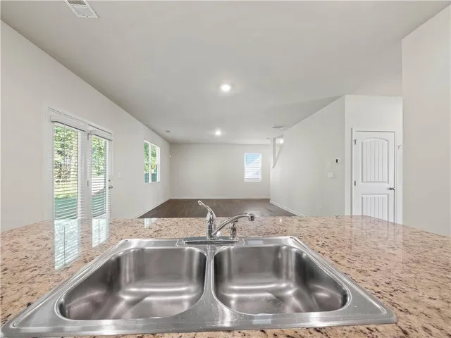 a kitchen with kitchen island a sink and a window
