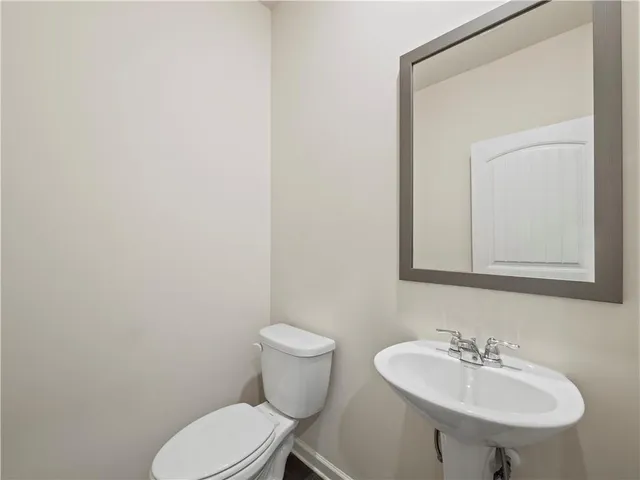 a bathroom with a sink a mirror and a toilet