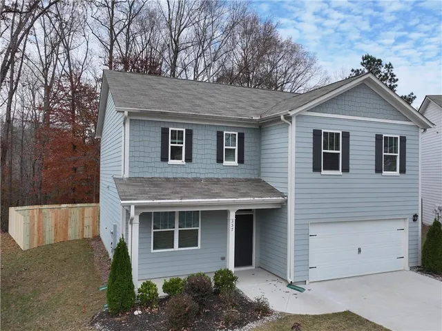 a front view of a house with a yard