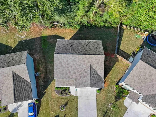 an aerial view of a house with outdoor space and sitting area