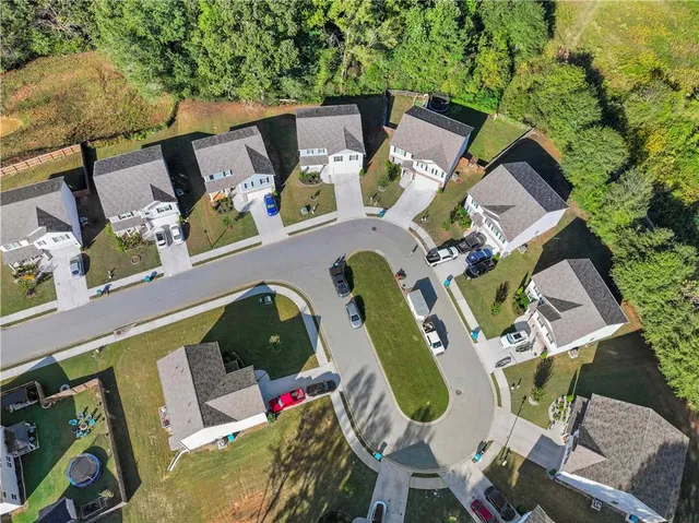 an aerial view of residential houses with outdoor space