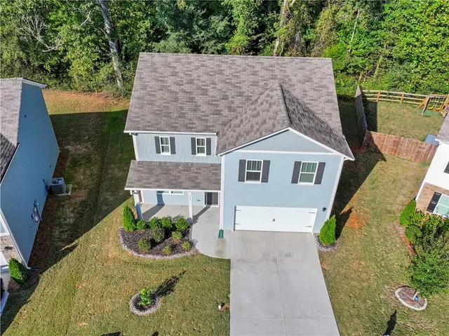 an aerial view of a house with a yard