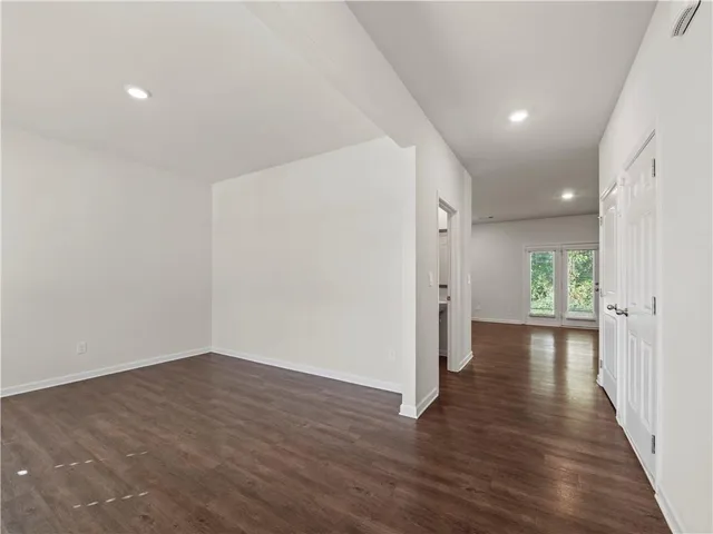 a view of a hallway with wooden floor